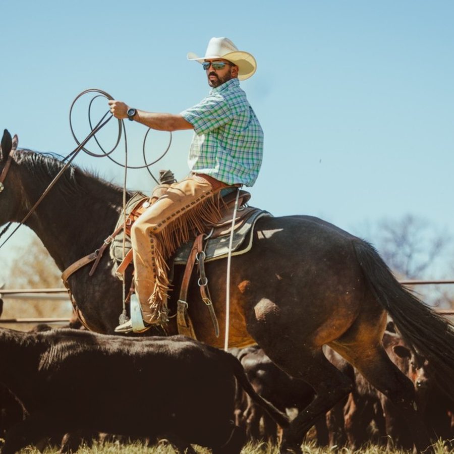 Jordan Fletcher roping cattle from horseback on a Montana ranch